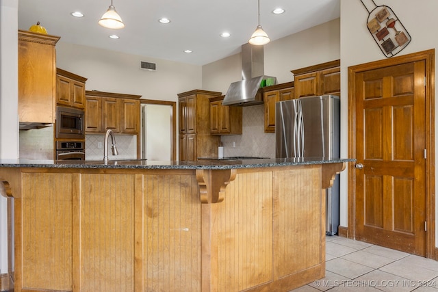 kitchen with stainless steel appliances, kitchen peninsula, island range hood, pendant lighting, and light tile patterned floors