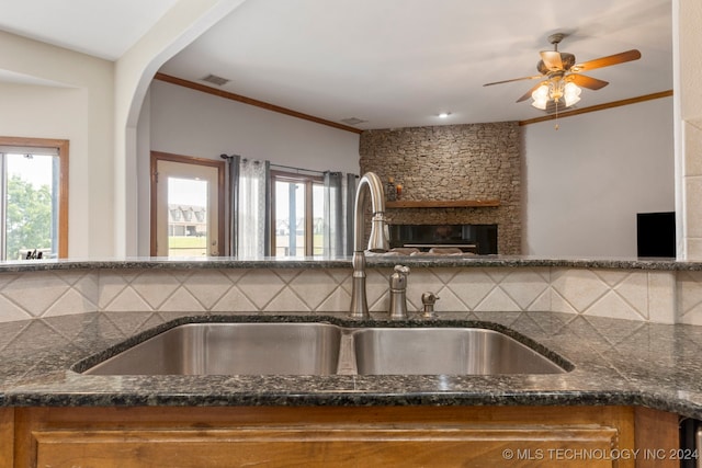 kitchen with a wealth of natural light, sink, and backsplash