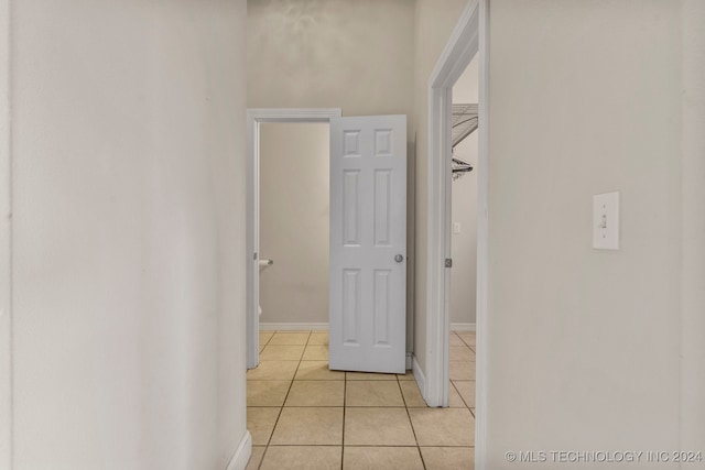 corridor with light tile patterned floors