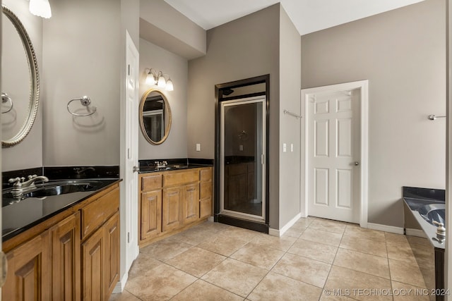 bathroom featuring independent shower and bath, vanity, and tile patterned flooring