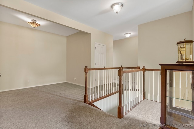 hallway featuring dark colored carpet