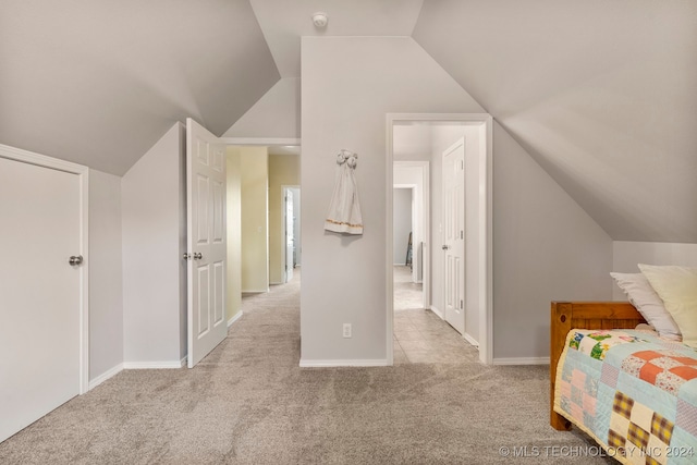 carpeted bedroom featuring lofted ceiling