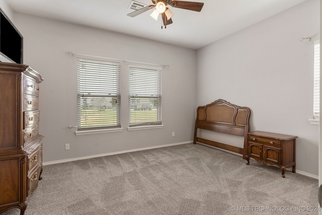 interior space featuring ceiling fan and light carpet