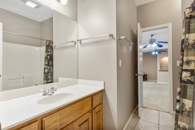 bathroom featuring tile patterned flooring, curtained shower, vanity, and ceiling fan