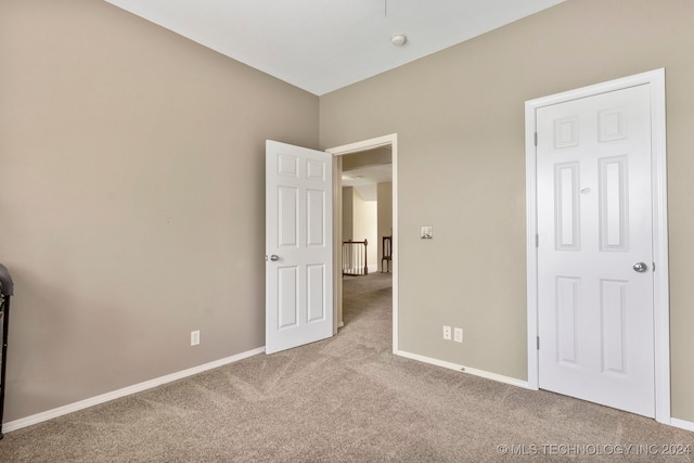 unfurnished bedroom featuring light colored carpet