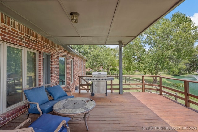 wooden terrace featuring a fire pit and grilling area