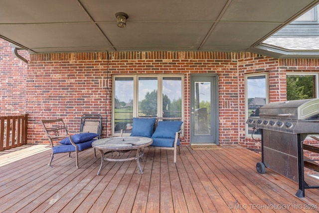 wooden deck with a grill