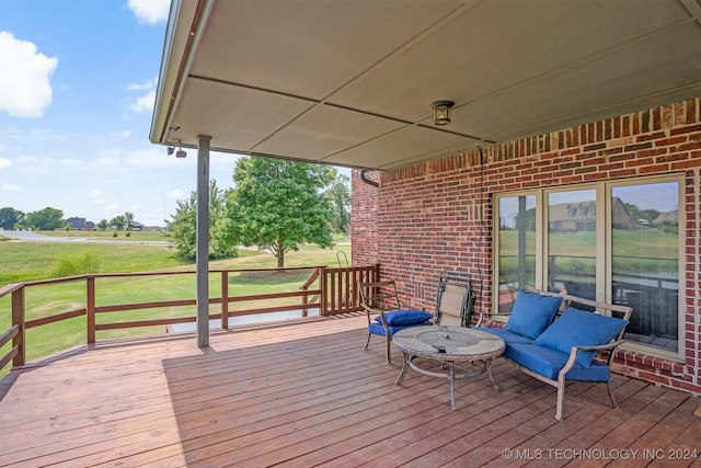 wooden deck with a lawn