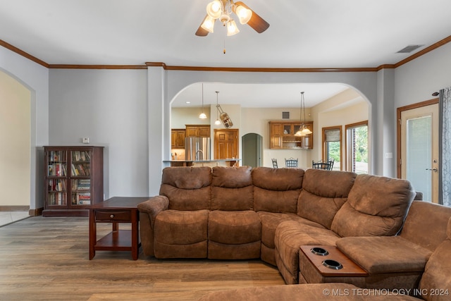 living room with ornamental molding, ceiling fan, and hardwood / wood-style floors