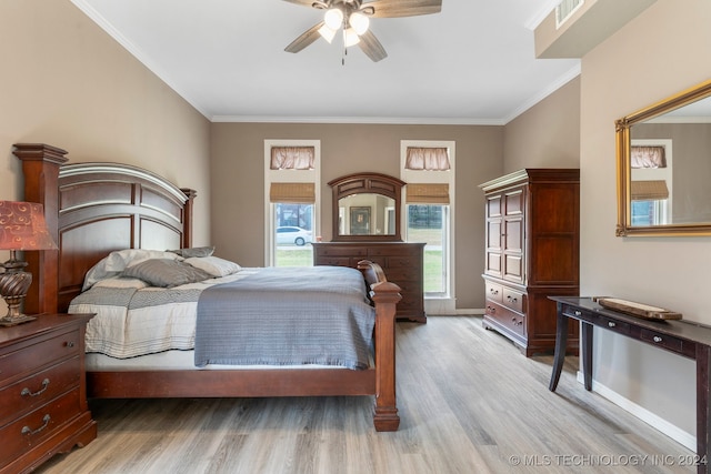 bedroom with crown molding, ceiling fan, and light hardwood / wood-style flooring