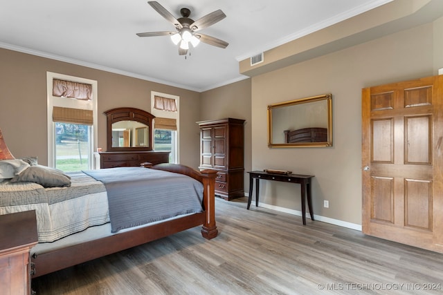 bedroom featuring ornamental molding, ceiling fan, and light hardwood / wood-style flooring