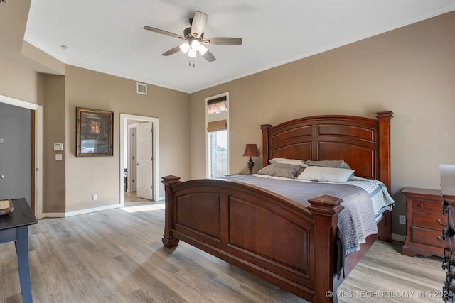 bedroom with ceiling fan, light hardwood / wood-style flooring, and ornamental molding