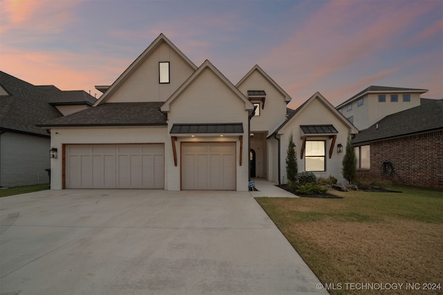 view of front facade featuring a yard and a garage