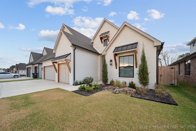 view of front of home featuring a front lawn and a garage