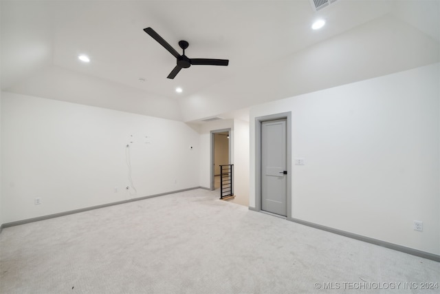 carpeted empty room with lofted ceiling and ceiling fan