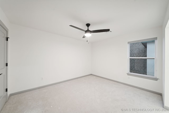 spare room with light carpet and ceiling fan