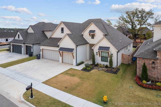 view of front of property with a front yard and a garage