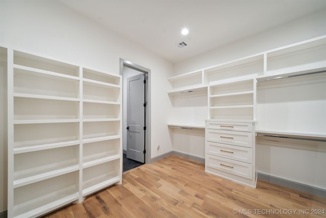 spacious closet with light hardwood / wood-style flooring