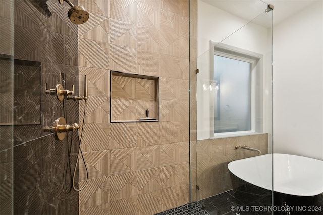 bathroom featuring independent shower and bath and tile walls