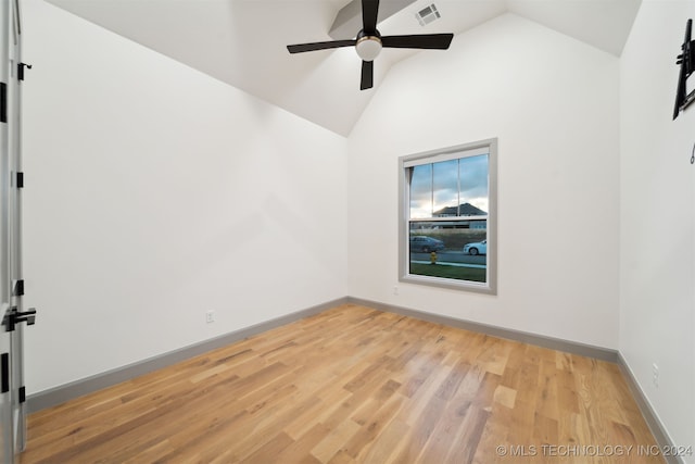 unfurnished room featuring ceiling fan, high vaulted ceiling, and light wood-type flooring