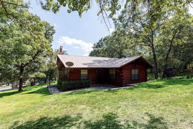 log cabin featuring a front lawn