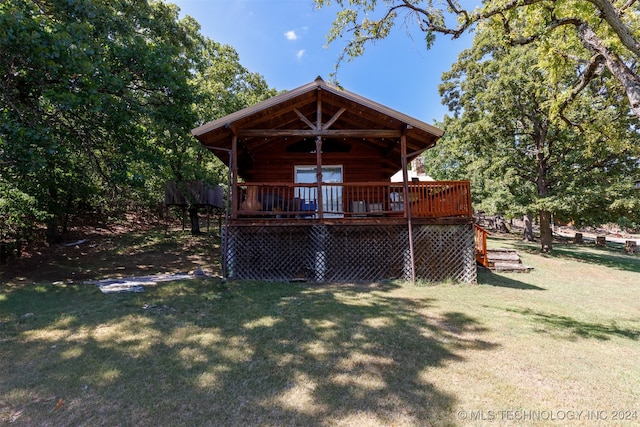 rear view of house with a deck and a lawn