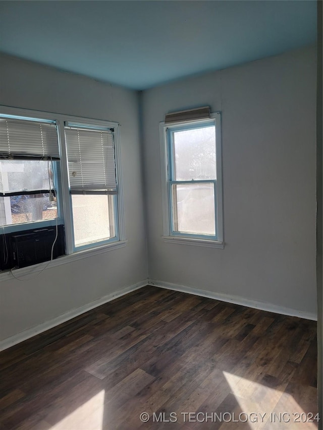 unfurnished room with dark hardwood / wood-style floors