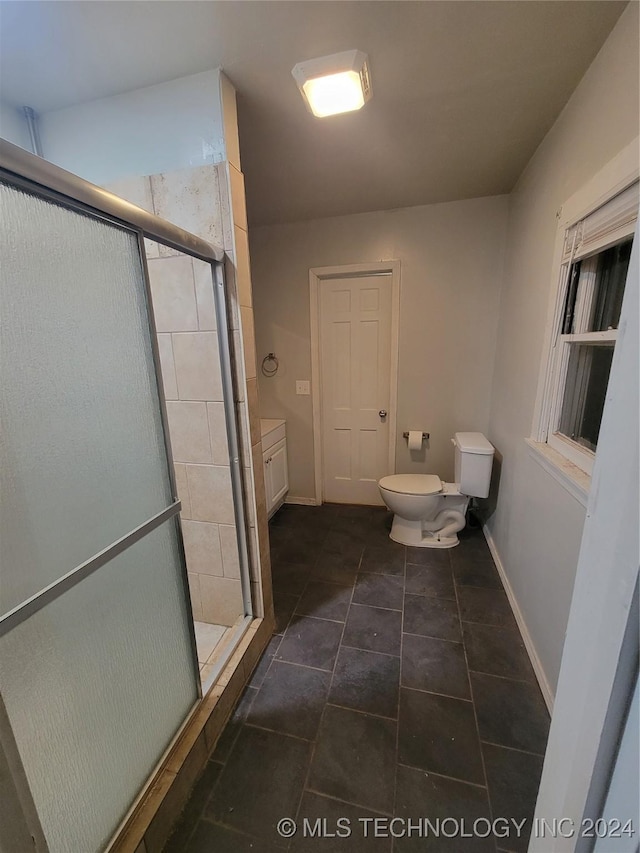 bathroom with vanity, an enclosed shower, tile patterned floors, and toilet