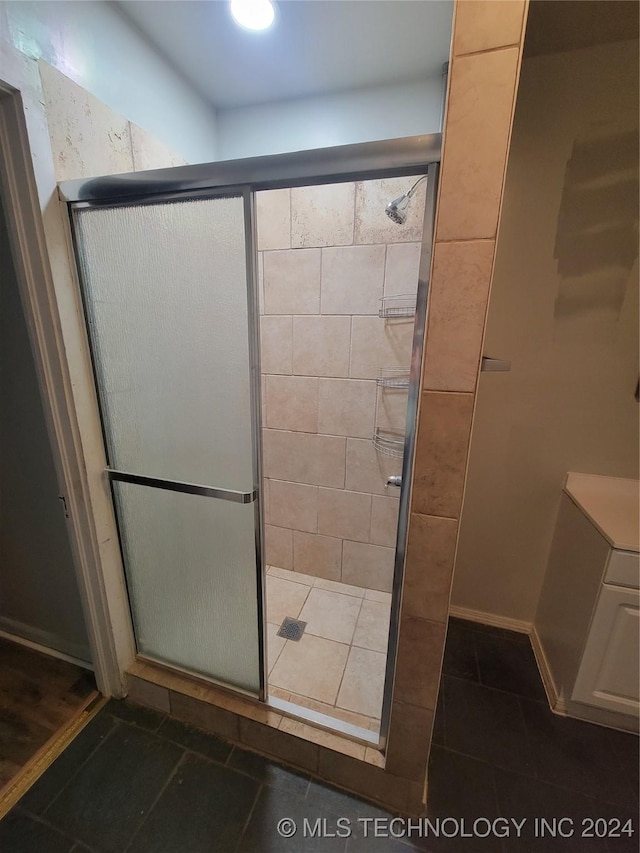 bathroom featuring an enclosed shower and tile patterned floors