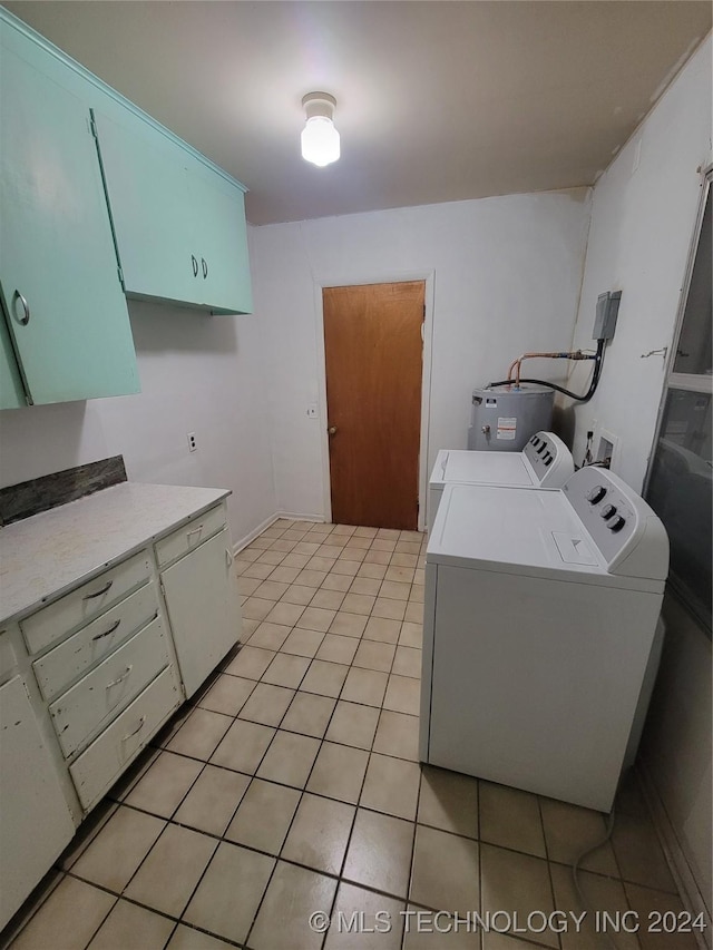 laundry area with independent washer and dryer, cabinets, electric water heater, and light tile patterned floors