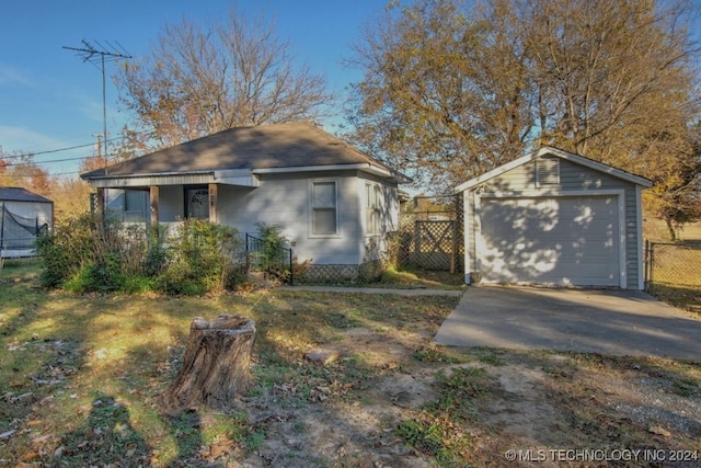 view of front facade with an outbuilding and a garage