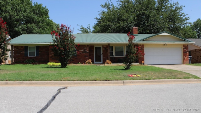 ranch-style house featuring a garage and a front yard