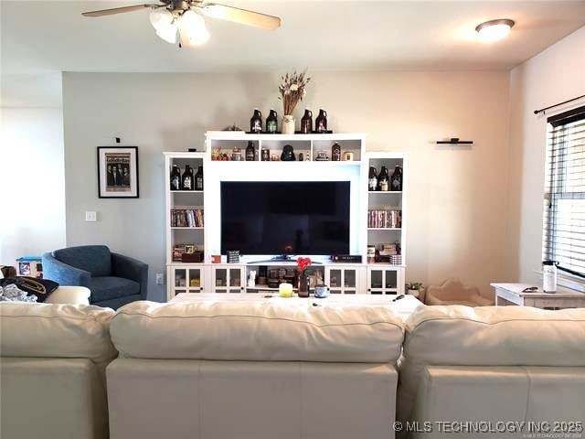 living area with ceiling fan