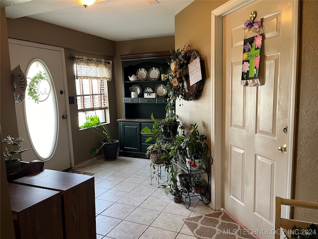 foyer entrance featuring light tile patterned flooring