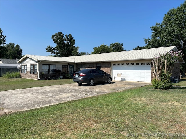 single story home featuring a garage and a front lawn