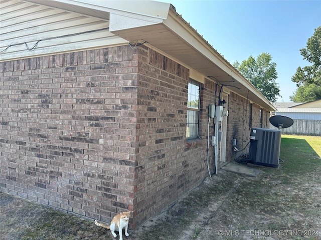 view of side of home with central AC unit