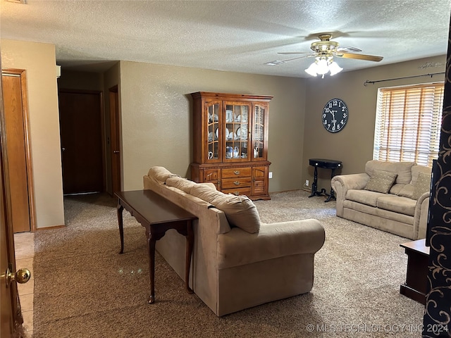 living room with carpet flooring, a textured ceiling, and ceiling fan