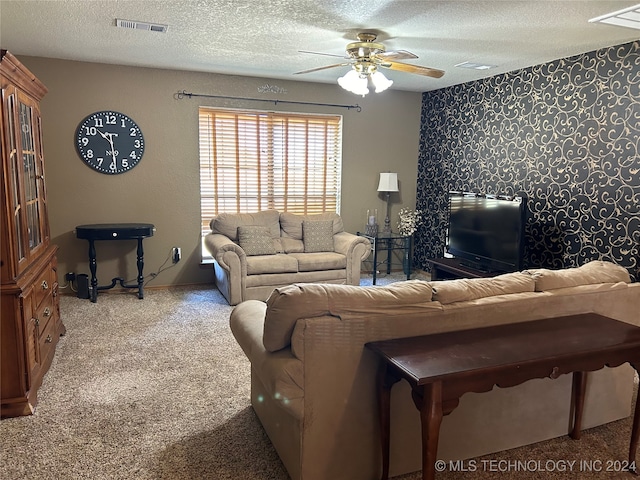 carpeted living room featuring a textured ceiling and ceiling fan