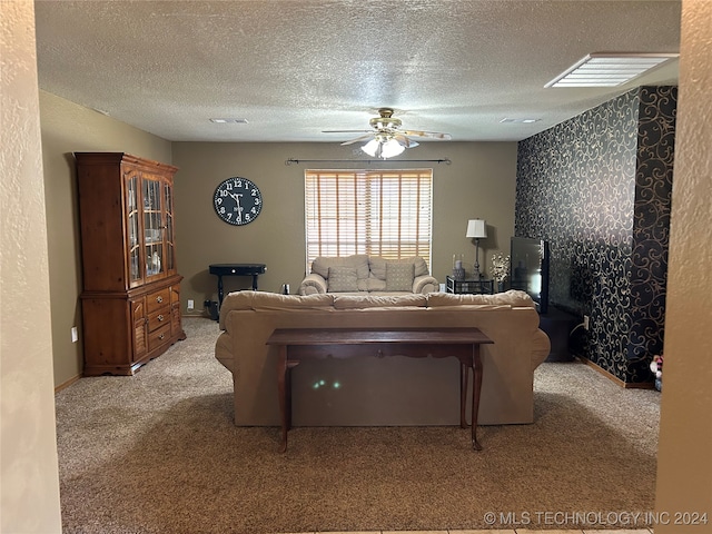 living room featuring light carpet, a textured ceiling, and ceiling fan