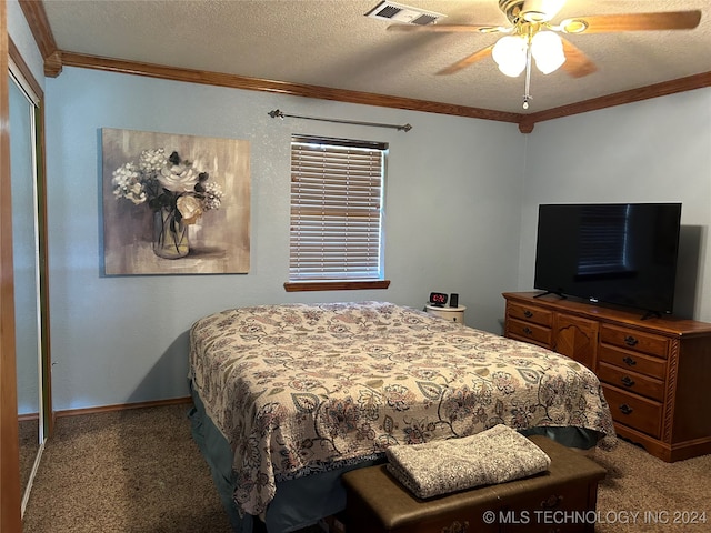 carpeted bedroom featuring a textured ceiling, ceiling fan, ornamental molding, and a closet