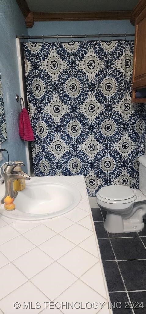 bathroom with tile patterned flooring, toilet, and vanity