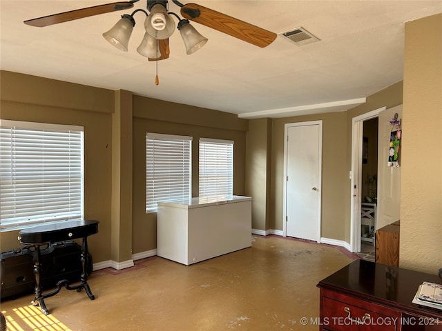 interior space with concrete flooring and ceiling fan