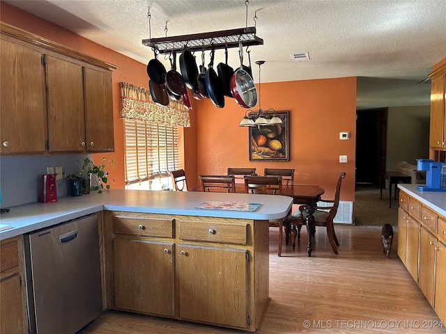 kitchen with light hardwood / wood-style flooring, dishwasher, a textured ceiling, and kitchen peninsula