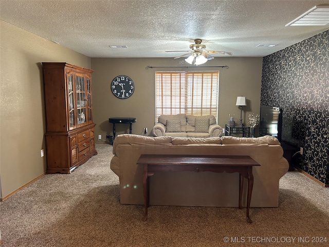 living room with light colored carpet, a textured ceiling, and ceiling fan