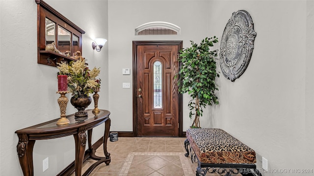 entryway with light tile patterned flooring