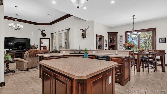 kitchen featuring pendant lighting, black dishwasher, an inviting chandelier, and a kitchen island