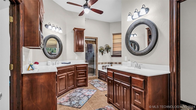 bathroom with tile patterned flooring, vanity, and ceiling fan