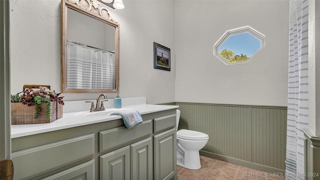 bathroom featuring vanity, toilet, and tile patterned flooring