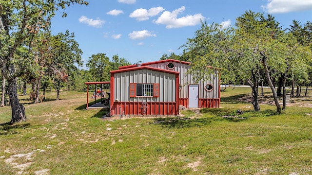 view of outbuilding with a yard