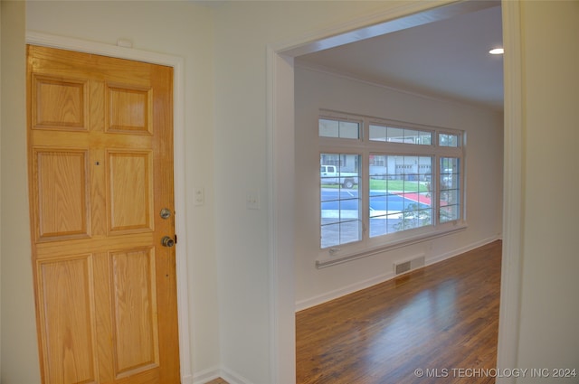 entryway featuring ornamental molding and dark hardwood / wood-style floors